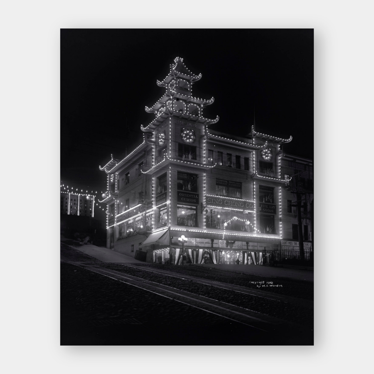 Chinatown building at California Street and Grant Avenue lit up at night, 1908