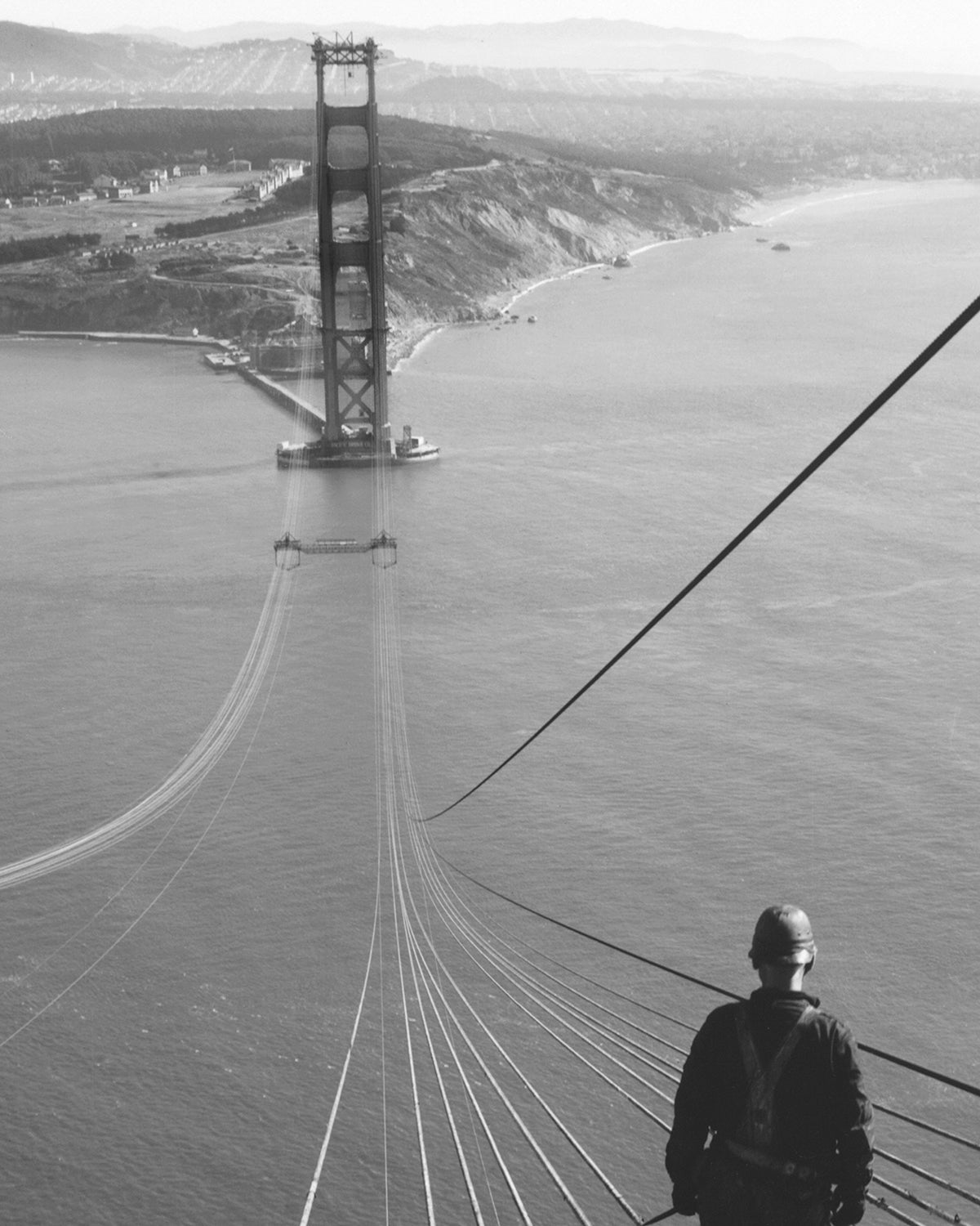 Man Standing on Cables of Golden Gate Bridge During Construction, 1935.