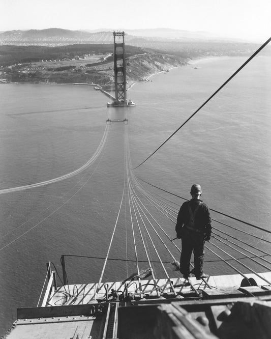 Man Standing on Cables of Golden Gate Bridge During Construction, 1935.